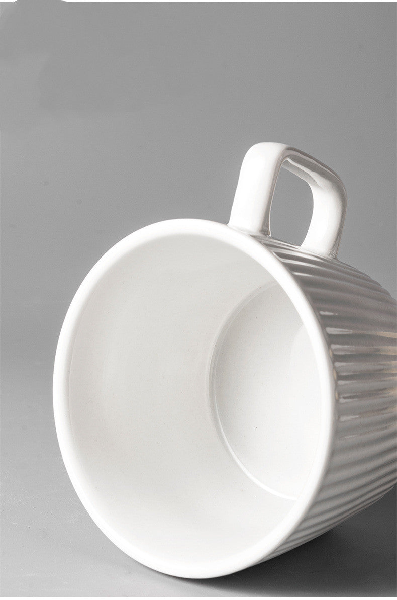 Vintage Style Ribbed Mug in Vanilla Steamer color. on its side, with view of inside the mug.