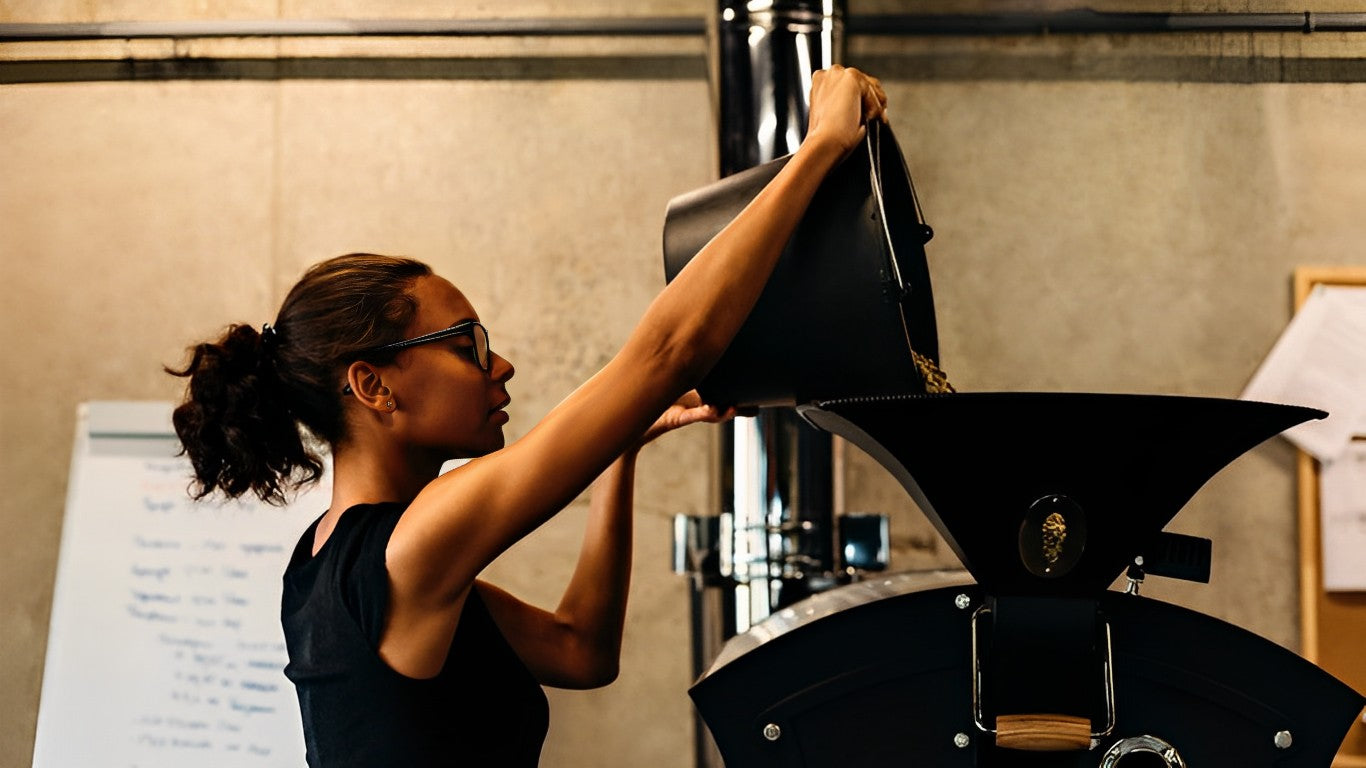 A woman looking into a commercial roaster machine.