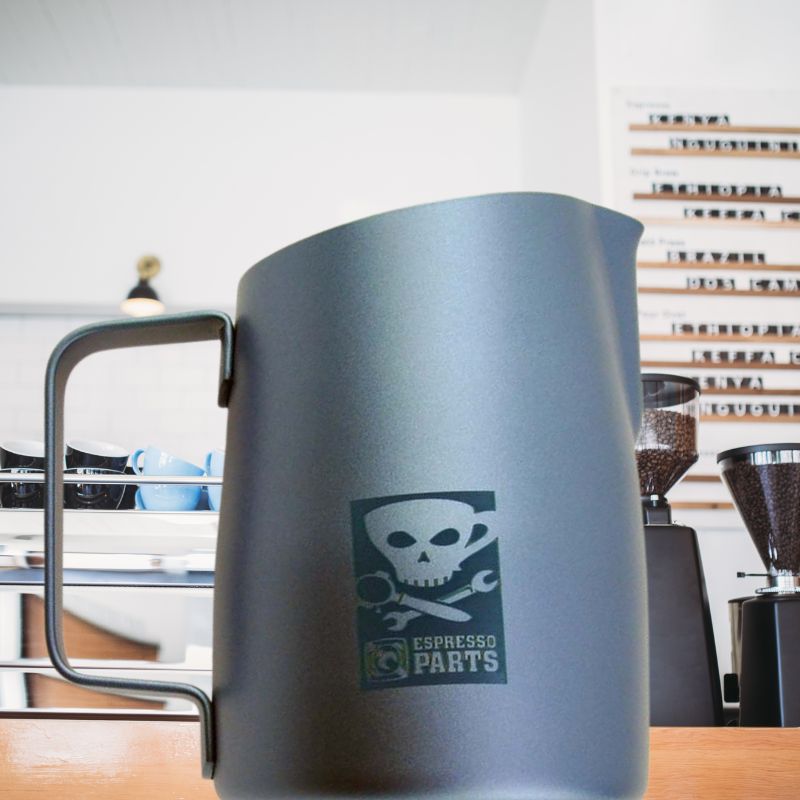 Stylish Barista Milk Pitcher with Cool Skull Design by Espresso Parts on the countertop of a cafe