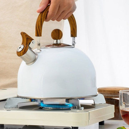 A person holding a White Kitchen Kettle with Wooden Handle over a beige1 burner portable stove.