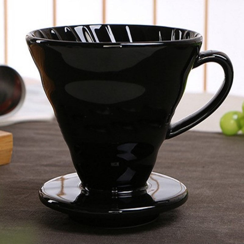 Black Ceramic Pour Over Coffee Filter sitting on a table top covered in a dark gray table cloth.