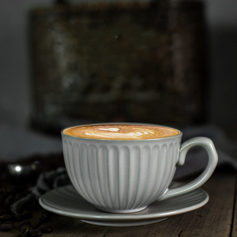 Vintage style ceramic mug and saucer in light gray color.