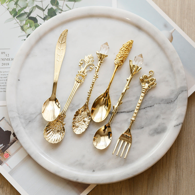 Medieval-Style Retro Coffee Spoons Set in Gold, all together on a plate