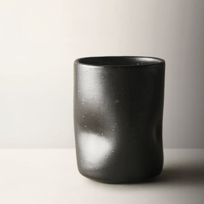 Misshapen Magic Japanese Style Tea Cup Mug in charcoal black color.