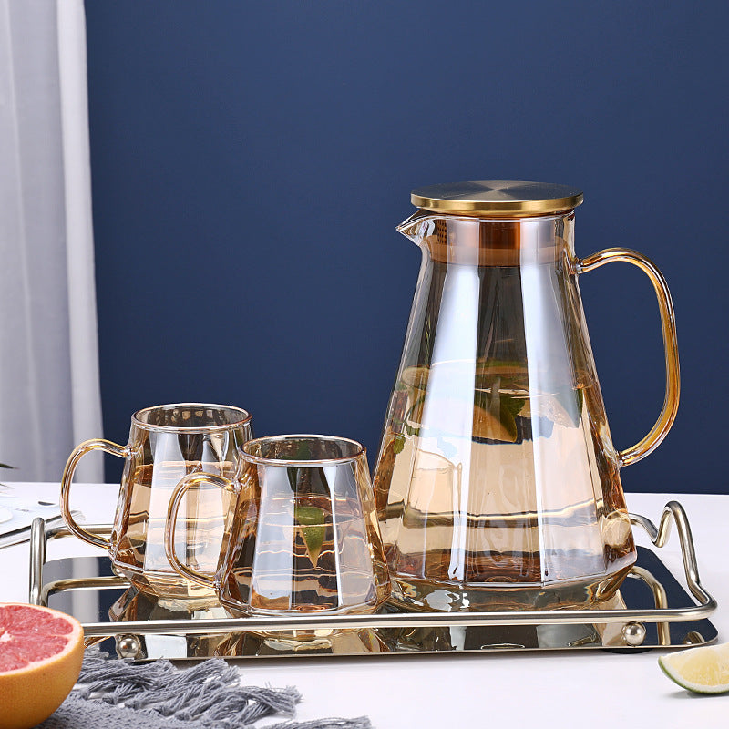 Diamond-Shaped Glass Pitcher and 2 glasses in transparent champagne color, on a stainless steel serving tray 