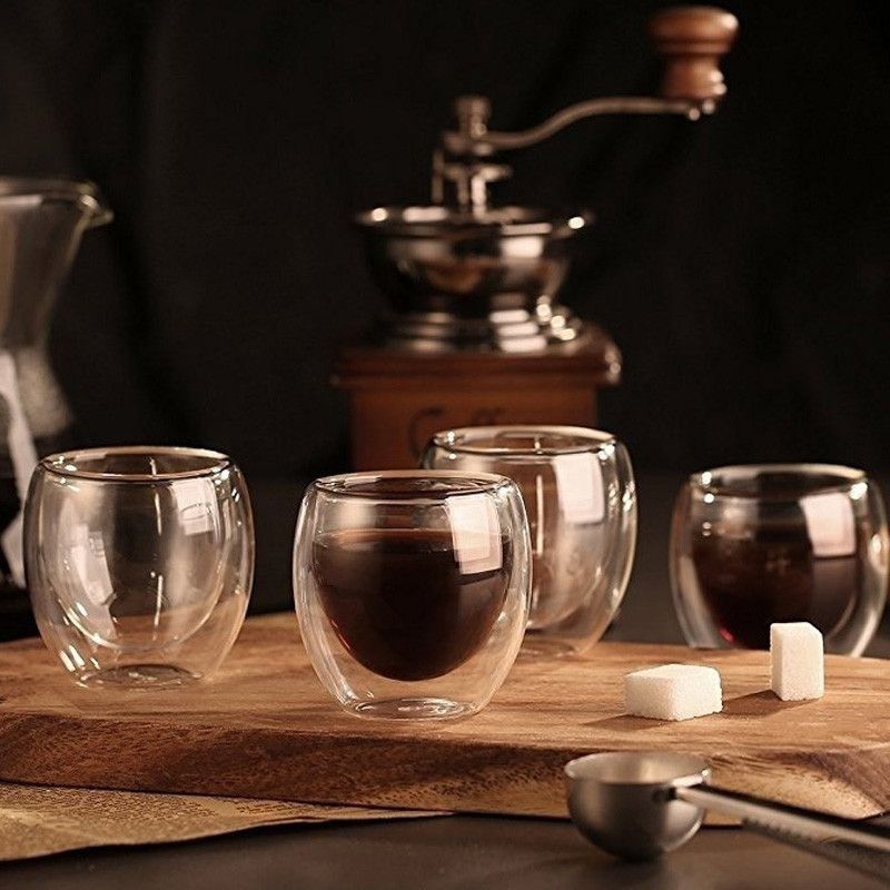 4 Double-Walled Glass Espresso Glasses on a table. 2 are filled with espresso.