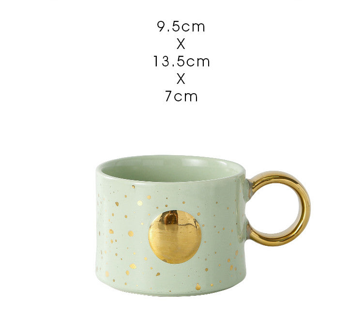 Golden Accented ceramic Mug in light green with Sun Design with measurements typed out above it.