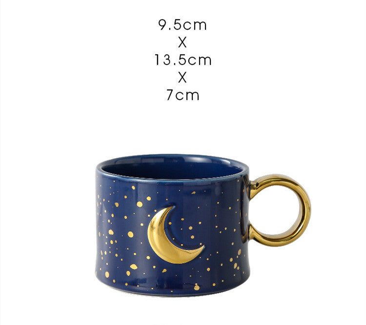 Golden Accented ceramic Mug with moon Design in navy blue with measurements typed out above it.