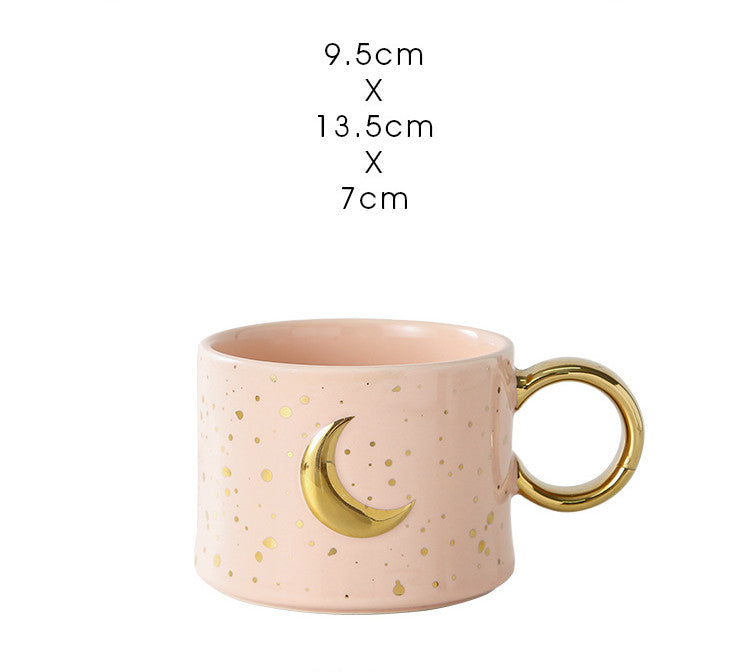 Golden Accented ceramic Mug with moon Design in pink with measurements typed out above it.