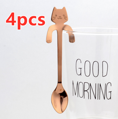 Hanging Cat Spoon in Rose Gold on glass cup that says good morning