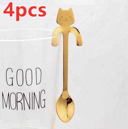 Hanging Cat Spoon in Gold on glass cup that says good morning