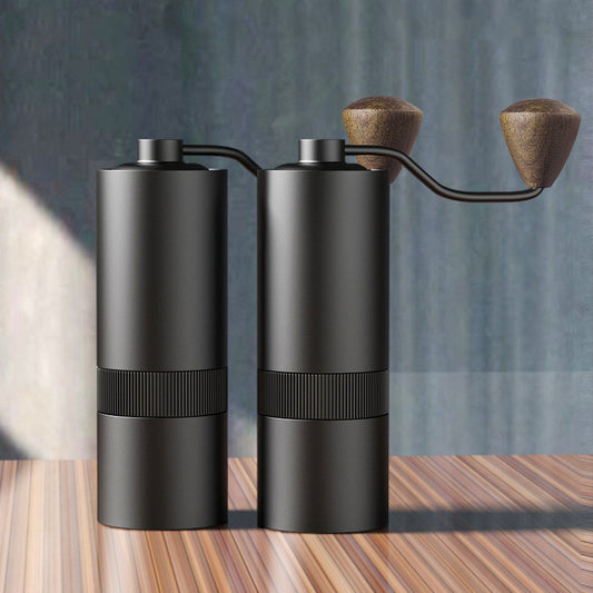 2 Sleek Black Compact Manual Coffee Grinders side by side on a wooden tablw.