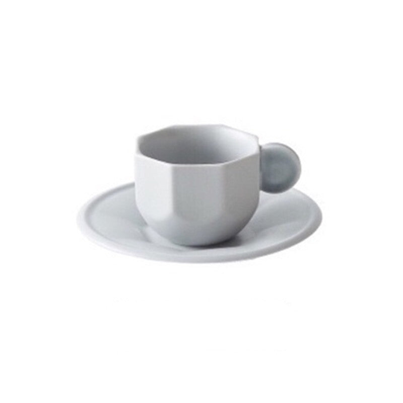 Gray octagonal Shaped Mug with Macaron Handle and saucer on white background.