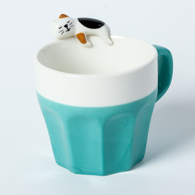 Cat On The Rim Mug in turquoise green.