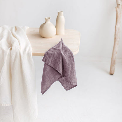 Linen Tea Towel on table with two vases and another piece of cloth.