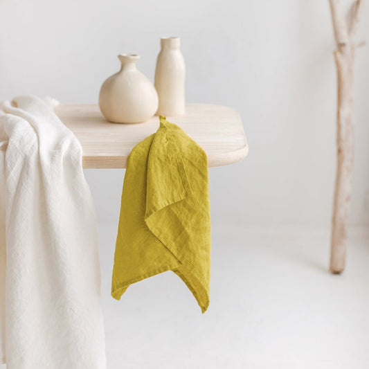 Linen Tea Towel on table with two vases and another piece of cloth.