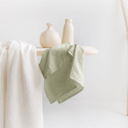 Linen Tea Towel on table with two vases and another piece of cloth.