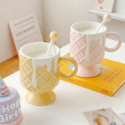 2 Ice Cream Coffee Cups With Mixing Spoons on a table that has books stacked on it and other pieces of paper.