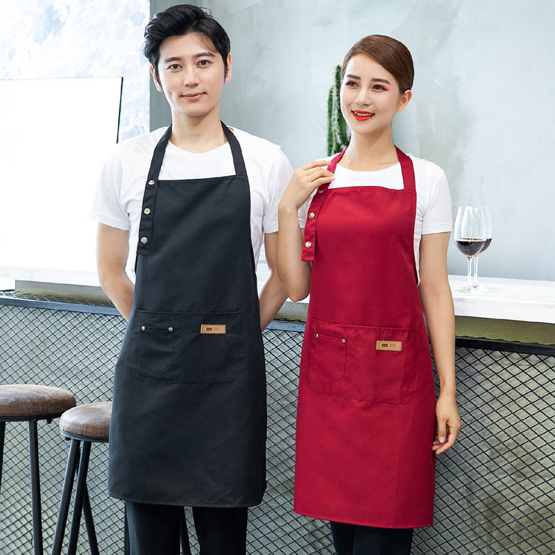 A man wearing a black apron and a woman wearing an red one.High-Quality Cotton Barista Aprons