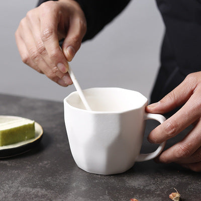 Man holding a spoon and the White Diamond-Shaped Ceramic Mug