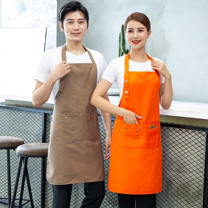 High-Quality Cotton Barista Aprons. A man wearing a beige brown apron and a woman wearing an orange one.