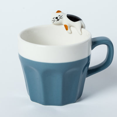 Cat On The Rim Mug in muted blue.