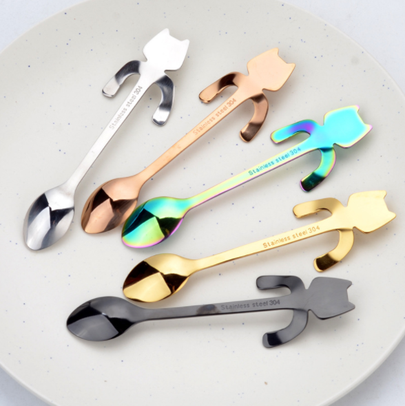 Hanging Bear and Cat Spoons in Rainbow, Black, Rose Gold, Silver, And Gold on a white plate