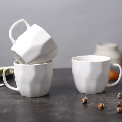 White Diamond-Shaped Ceramic Mugs on a table