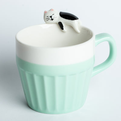 Cat On The Rim Mug in pale peppermint green.