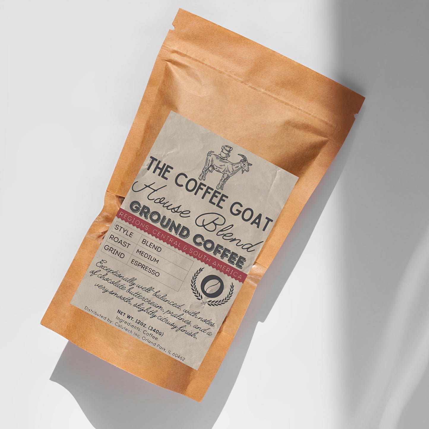 A 12oz brown kraft bag of The Coffee Goat's "House Blend" Specialty Medium Roast Ground Coffee