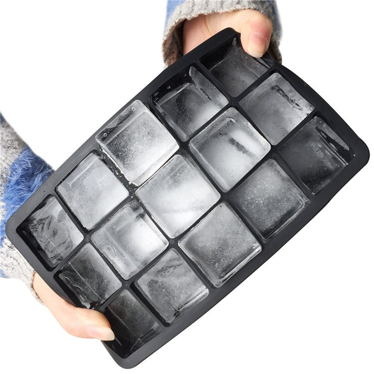 Person holding a 15 cube premium silicone ice cube tray with frozen ice in it.