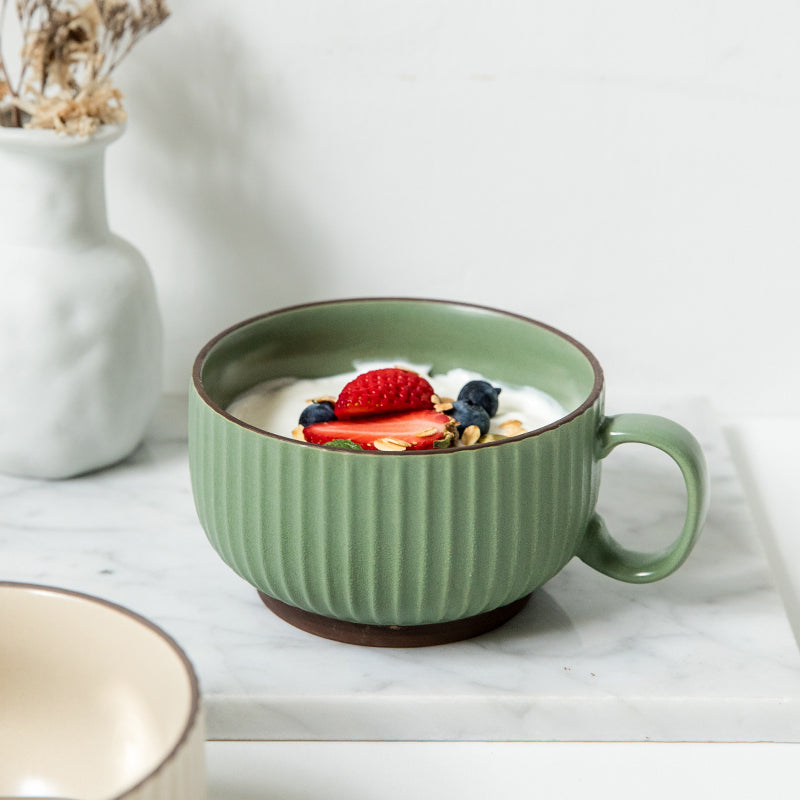 Ribbed Scandinavian Style Coffee Mug in earth green with cereal, berries, and milk in it.