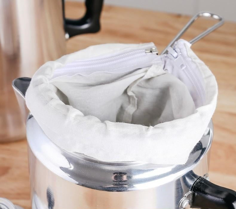 Cold Brew Cloth Coffee Filter Brewing Net inside of a stainless steel jug.