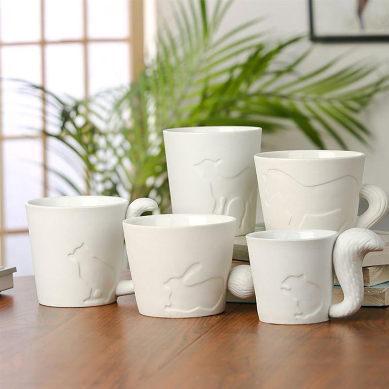 5 Adorable Animal Ceramic Mugs on a table with green plant tree in the background. All 5 styles are on the table (deer, horse, fox, rabbit, and a squirrel))